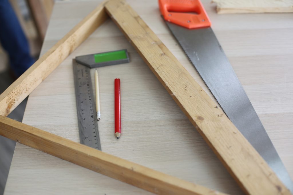 Carpenter grinding joinery product with carvings, finishing woodwork at the carpentry manufacturing