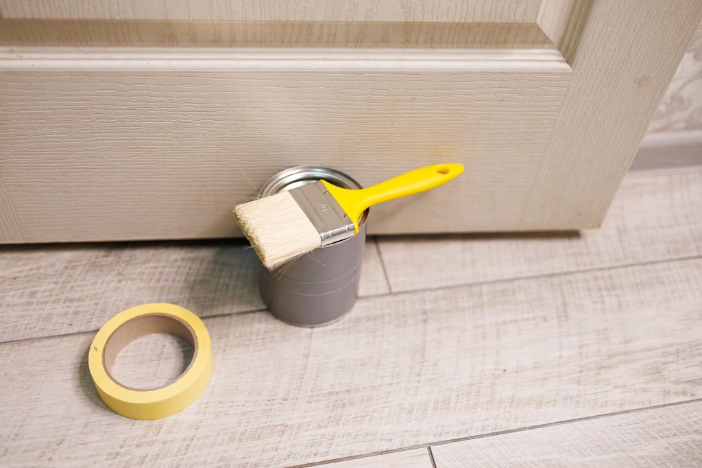 Prepare for coloring with a paintbrush and paint. Repair staining the doors with paint.